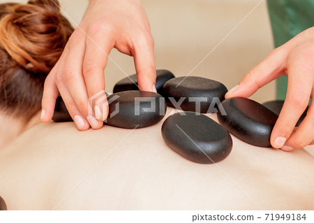 Massage stones on back. 71949184