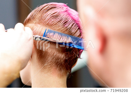 Hands cuts hair of woman. Hands cuts hair of woman. 71949208