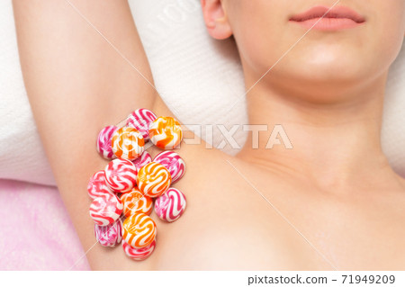 Candy on female armpit. 71949209