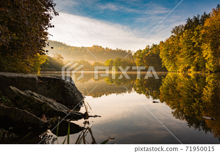Lake fog landscape with Autumn foliage and tree reflections in Styria, Thal, Austria Lake fog landscape with Autumn foliage and tree reflections in Styria, Thal, Austria 71950015