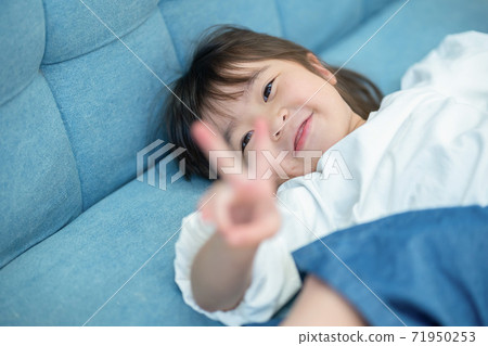 Girl playing on the sofa 71950253