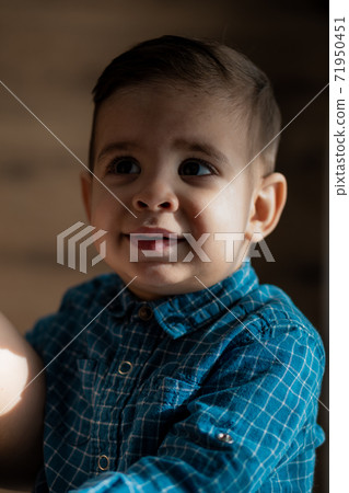 Childhood, family, loneliness concepts - Little preschool black boy in blue clothes Persian Arab appearance of two years of mixed nationality sitting on soft light bed with pacifier in mouth at home Childhood, family, loneliness concepts - Little preschool black boy in blue clothes Persian Arab appearance of two years of mixed nationality sitting on soft light bed with pacifier in mouth at home 71950451