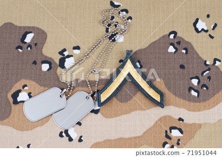 May 12, 2018. US ARMY Private rank patch and dog tags on Desert Battle Dress Uniform  71951044