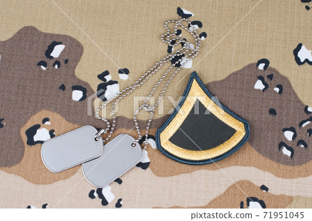 May 12, 2018. US ARMY Private First Class rank patch and dog tags on Desert Battle Dress Uniform May 12, 2018. US ARMY Private First Class rank patch and dog tags on Desert Battle Dress Uniform 71951045