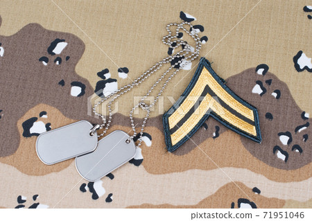 May 12, 2018. US ARMY Corporal rank patch and dog tags on Desert Battle Dress Uniform  71951046