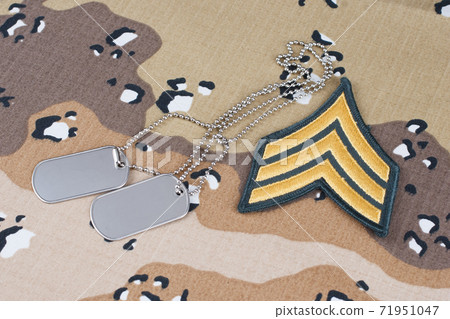 May 12, 2018. US ARMY Sergeant rank patch and dog tags on Desert Battle Dress Uniform May 12, 2018. US ARMY Sergeant rank patch and dog tags on Desert Battle Dress Uniform 71951047