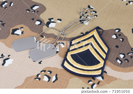 May 12, 2018. US ARMY Sergeant First Class rank patch and dog tags on Desert Battle Dress Uniform  71951050