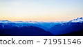 Dark snow-capped mountains at dusk. 71951546