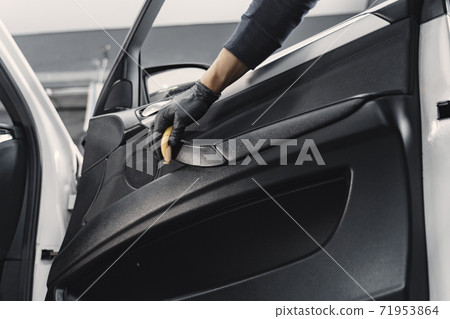 Man polish salon of car in a garage 71953864