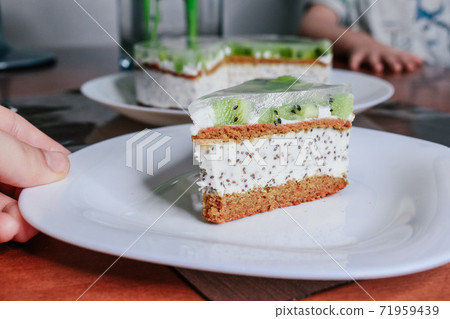 Raw vegan kiwi green cake decorated with slices. Coconut chia filling jelly vegetarian cashew cream cheesecake gluten free. Lactose sugar free holiday organic desert. Healthy eco cake Raw vegan kiwi green cake decorated with slices. Coconut chia filling jelly vegetarian cashew cream cheesecake gluten free. Lactose sugar free holiday organic desert. Healthy eco cake 71959439
