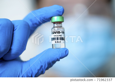 Doctor hand showing COVID-19 Vaccine Doctor hand showing COVID-19 Vaccine 71962337