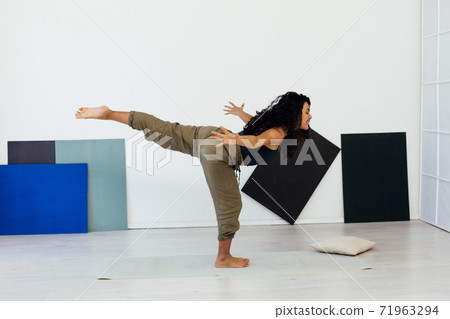Beautiful brunette woman engaged in yoga asana gymnastics fitness flexibility body sport Beautiful brunette woman engaged in yoga asana gymnastics fitness flexibility body sport 71963294