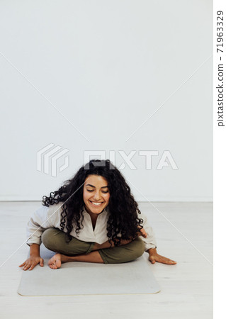 Female brunette engaged in yoga asana gymnastics sport 71963329
