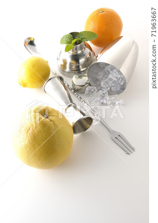 Make a cocktail with a shaker using grapefruit, orange, lemon and mint (white background) Make a cocktail with a shaker using grapefruit, orange, lemon and mint (white background) 71963667
