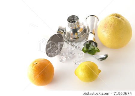 Make a cocktail with a shaker using grapefruit, orange, lemon and mint (white background) Make a cocktail with a shaker using grapefruit, orange, lemon and mint (white background) 71963674