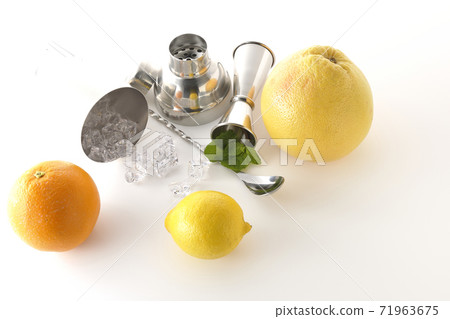 Make a cocktail with a shaker using grapefruit, orange, lemon and mint (white background) Make a cocktail with a shaker using grapefruit, orange, lemon and mint (white background) 71963675