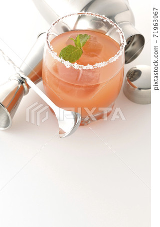 Photographed pink salty dog and cocktail shaker on a white background Photographed pink salty dog and cocktail shaker on a white background 71963967