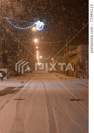 The street of Avetrana town under the snow after an unusual snowfall in Puglia, Salento 71964114
