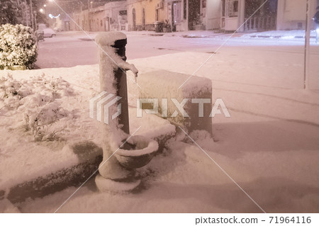Typical drinking fountain in the south of Italy, under the snow after an unusual snowfall in Puglia Typical drinking fountain in the south of Italy, under the snow after an unusual snowfall in Puglia 71964116