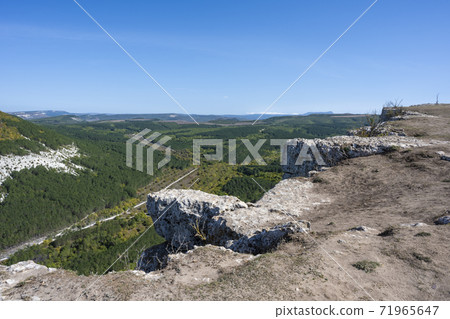 Panoramic mountain view from the cave city of Chufut-Kale in the Republic of Crimea, Russia. A clear Sunny day on September 28, 2020 Panoramic mountain view from the cave city of Chufut-Kale in the Republic of Crimea, Russia. A clear Sunny day on September 28, 2020 71965647