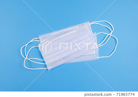 Medical protective face masks from coronavirus Covid-19 on blue table. Medical protective face masks from coronavirus Covid-19 on blue table. 71965774