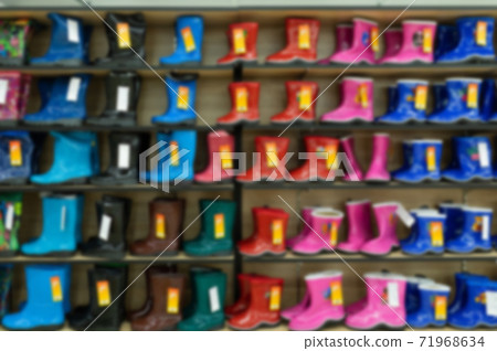 children's bright shoe store with a large selection of colors, models and sizes, blurred and 71968634