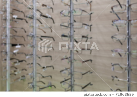 Blurred optics store with a large selection of fashionable eyeglass frames Blurred optics store with a large selection of fashionable eyeglass frames 71968689