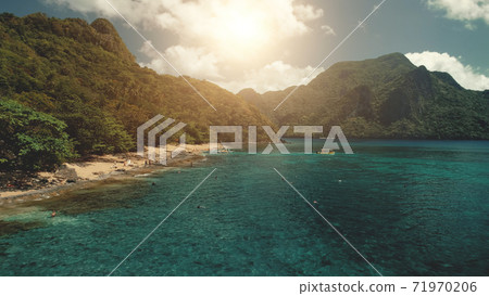 Sun sand beach at ocean aerial. Traveling boat on water. Tourist on sea coast rest at sunshine 71970206