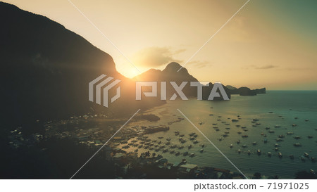 Sunset at mountainous islands at ocean harbor with dark silhouette. Highlands with tropic forest Sunset at mountainous islands at ocean harbor with dark silhouette. Highlands with tropic forest 71971025
