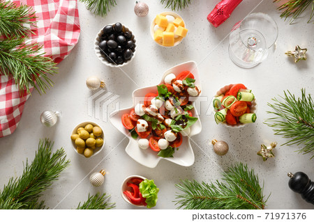 Caprese salad in plate shape of Christmas tree. Caprese salad in plate shape of Christmas tree. 71971376