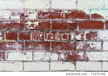 Brick wall textures. Painted problem wall surfaces. Red Stone Background. Worn facade of the building with damaged plaster. Brick wall textures. Painted problem wall surfaces. Red Stone Background. Worn facade of the building with damaged plaster. 71971780