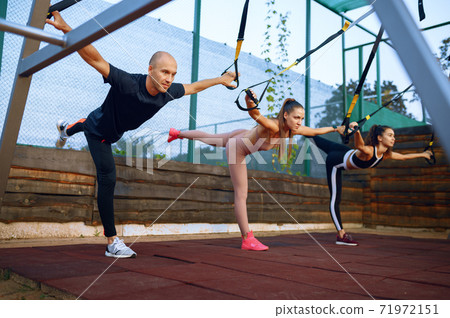 Man and women doing exercise, group training Man and women doing exercise, group training 71972151