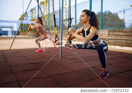 Slim women doing balance exercise, group training Slim women doing balance exercise, group training 71972152