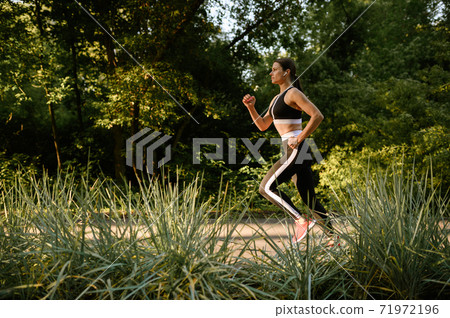 Morning run, woman on training in summer park Morning run, woman on training in summer park 71972196
