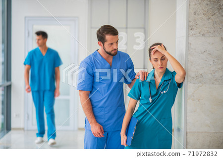 Female doctor feeling happy while her male colleague supporting her 71972832