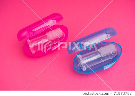Compact toothbrush fingertip. Travel hygiene close up Compact toothbrush fingertip. Travel hygiene close up 71973792