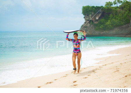Sexy slim girl with surf board on tropical sand beach. Healthy active lifestyle in summer vocation. Sexy slim girl with surf board on tropical sand beach. Healthy active lifestyle in summer vocation. 71974356