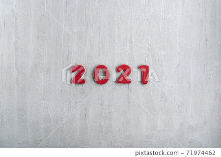 Inscription in red numbers 2021 from gingerbread on gray background. New Year 2021, copy space 71974462