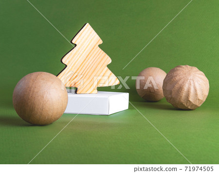The zero waste new year concept as a wooden fir tree on the green background. 71974505