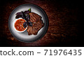 Roasted meat on a plate. Restaurant food. Grilled meat steak with sauce. Wooden background. T-bone. 71976435