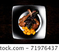 Grilled meat on a plate. Restaurant food. Lamb rack dish with pasta. 71976437
