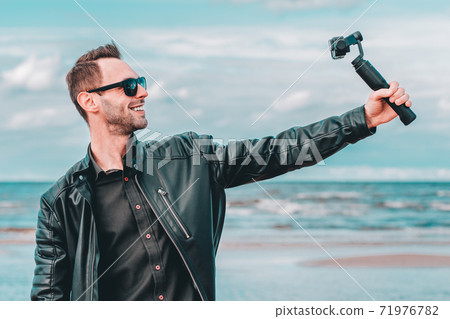 Handsome Guy Making Selfie at the Beach 71976782