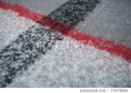 Closeup of red, black and grey woolen scarf texture Closeup of red, black and grey woolen scarf texture 71978666