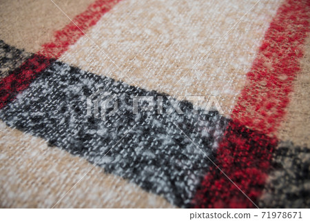 Closeup of beige and black woolen scarf texture 71978671