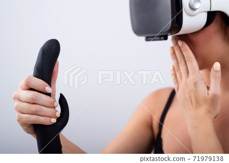 Black Dildo Finger - Woman in VR glasses with a black dildo on a... - Stock Photo [71979138] -  PIXTA