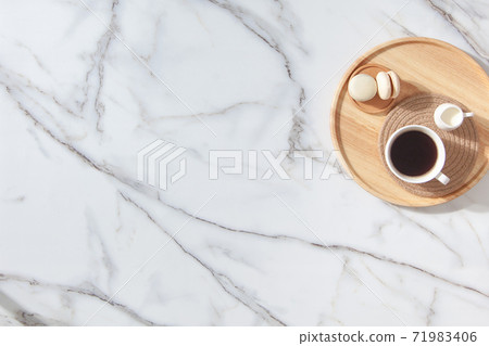 Flat lay composition of coffee, milk and macarons on wooden tray. Marble background Flat lay composition of coffee, milk and macarons on wooden tray. Marble background 71983406
