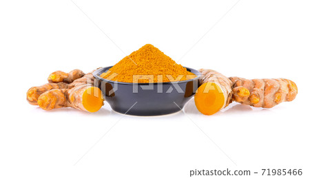 Turmeric roots and turmeric powder in bowl isolated on white background Turmeric roots and turmeric powder in bowl isolated on white background 71985466