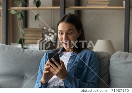 Amazed woman shocked by online deal on cellphone 71987170