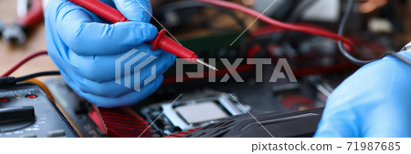 Gloved hands, on table repair an electronic device 71987685