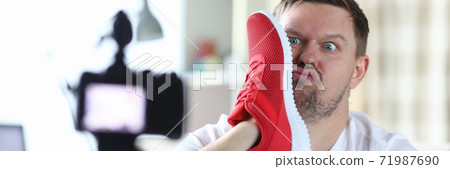 Man takes photo with sneaker face, front camera 71987690